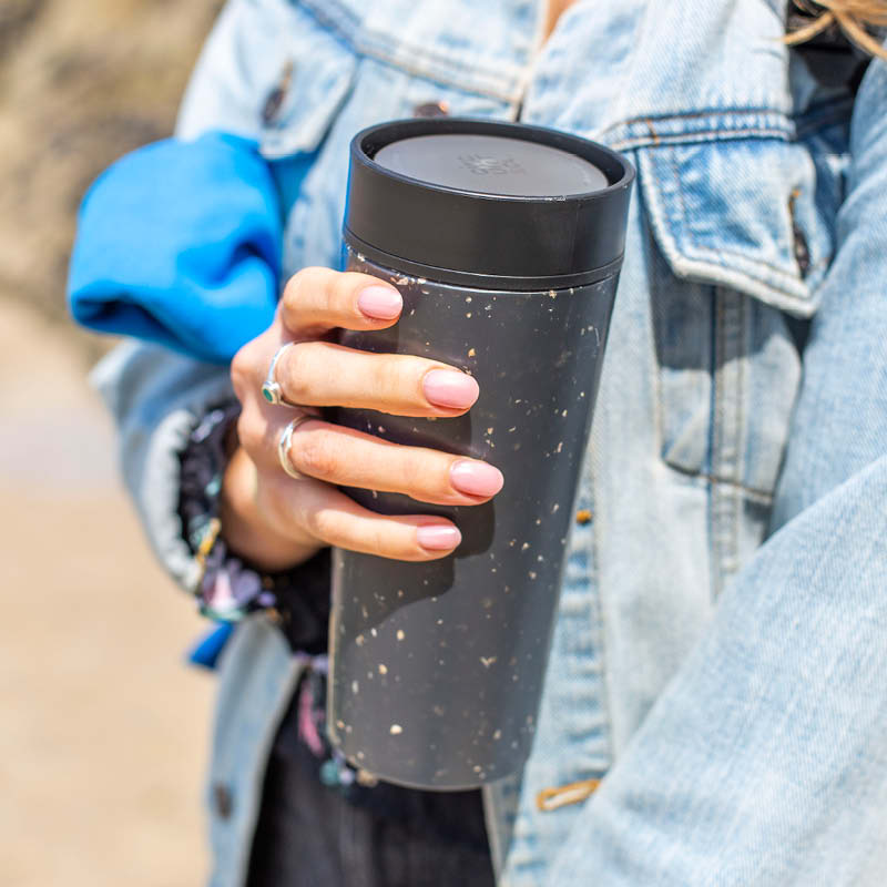 Person holding a Circular Co Black reusable cup