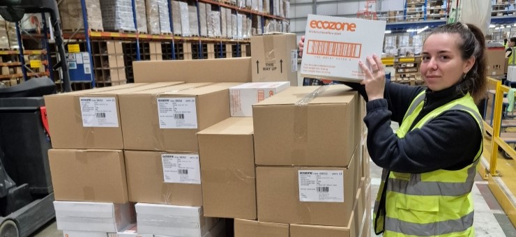 A member of the Ecozone team stood near boxes that will be donated to the foodbank