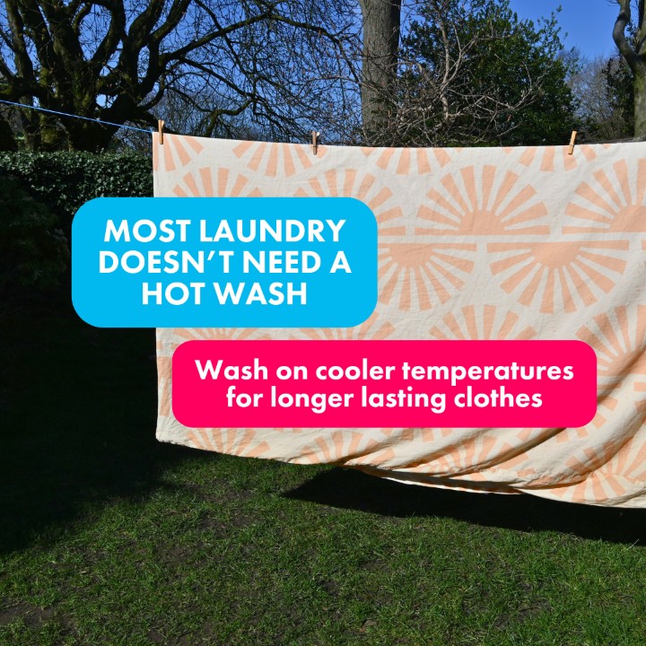 A duvet cover handing on a washing line with a copy overlay that says "most laundry doesn't need a hot wash" and "wash on cooler temperatures for longer lasting clothes"