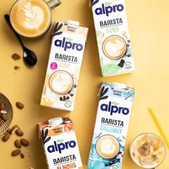 4 Alpro cartons from above on a yellow background
