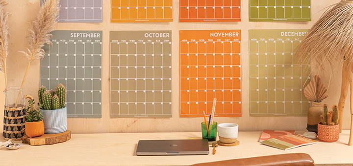 Good Tuesday monthly wall planner on a wall behind a desk