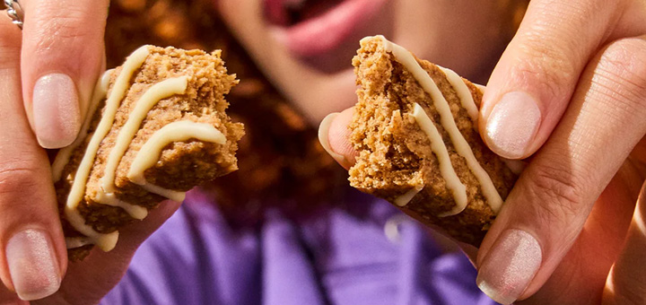 A close up of a MadeGood Oat Bar being snapped in two