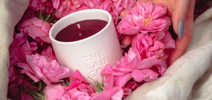 The Lab Co candle set against some pink roses