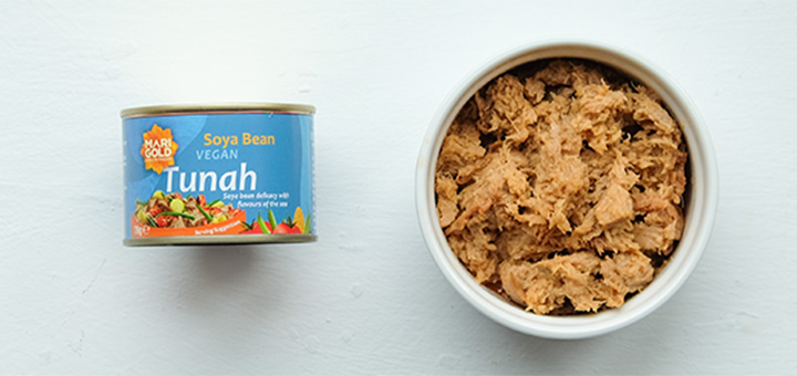 Marogold Tunah in a bowl next to the can. Shot from above against a white background