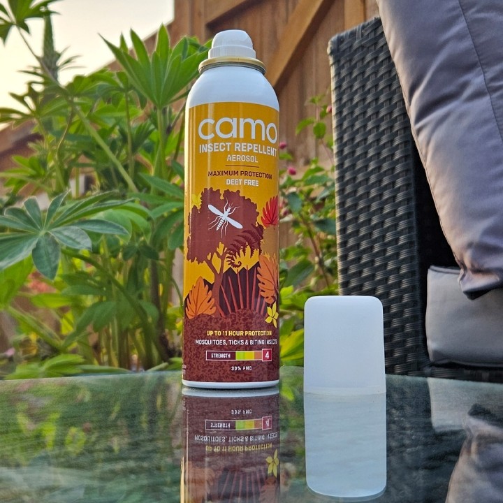Camo insect repellent on a table in a garden