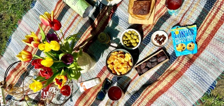 A birds eye view of a picnic laid out on a picnic rug